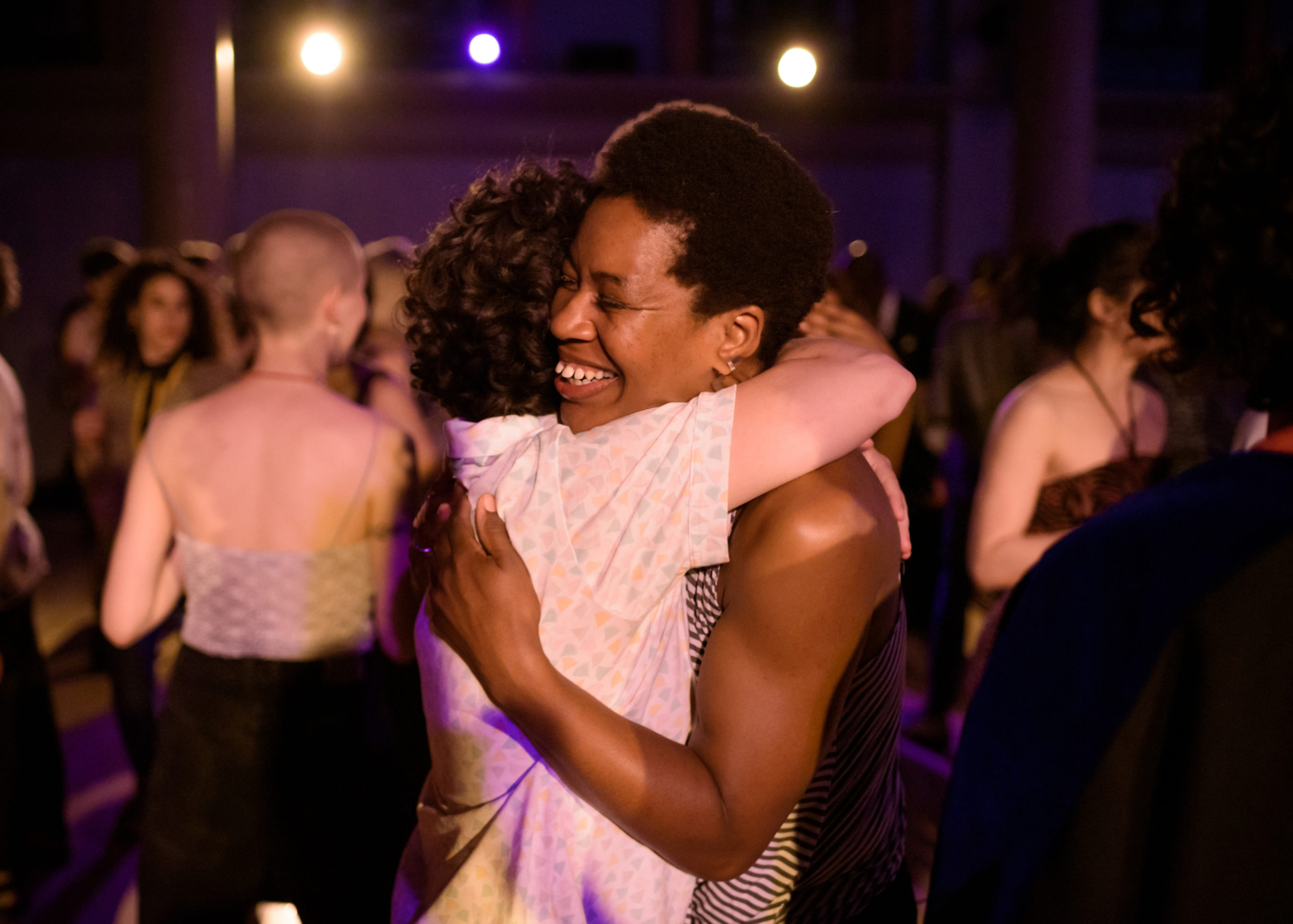 2 people hug each other on a dance floor