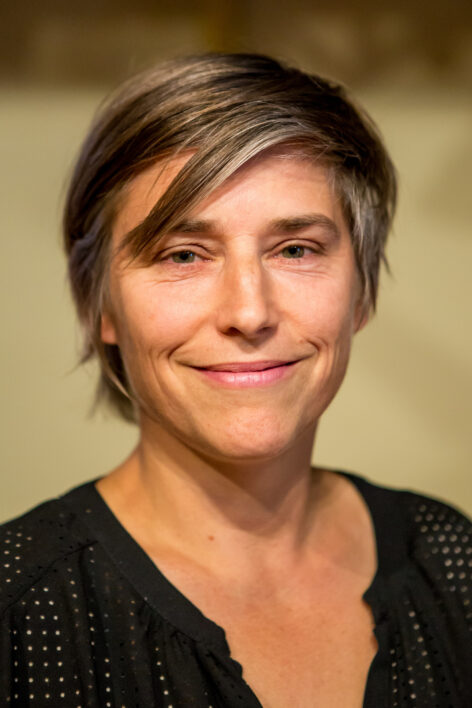 A white woman in her forties with short hair and black shirt. Photo by Peter Raper.