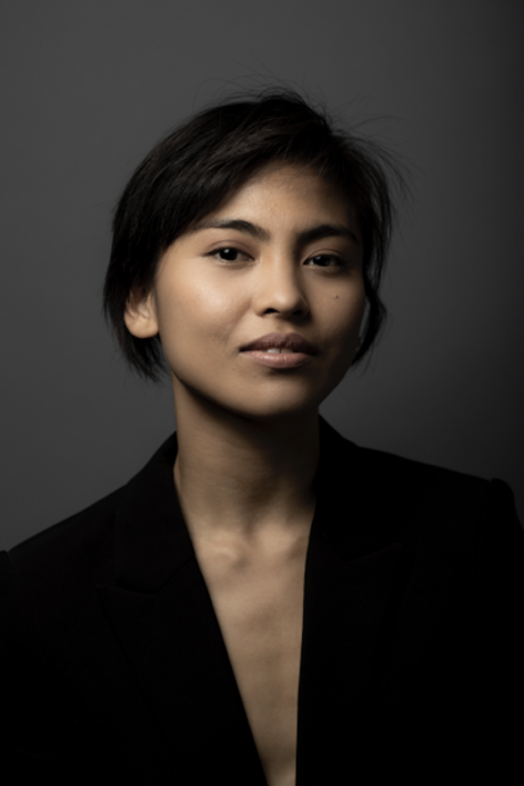 Photo of brown skinned Filipina American woman, wearing low v black blazer. Photo by Maria Baranova