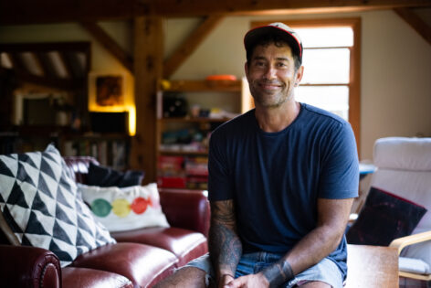 Jared Williams sits in the library at the Field Center in southern Vermont. Photo Credit: Anna Maynard