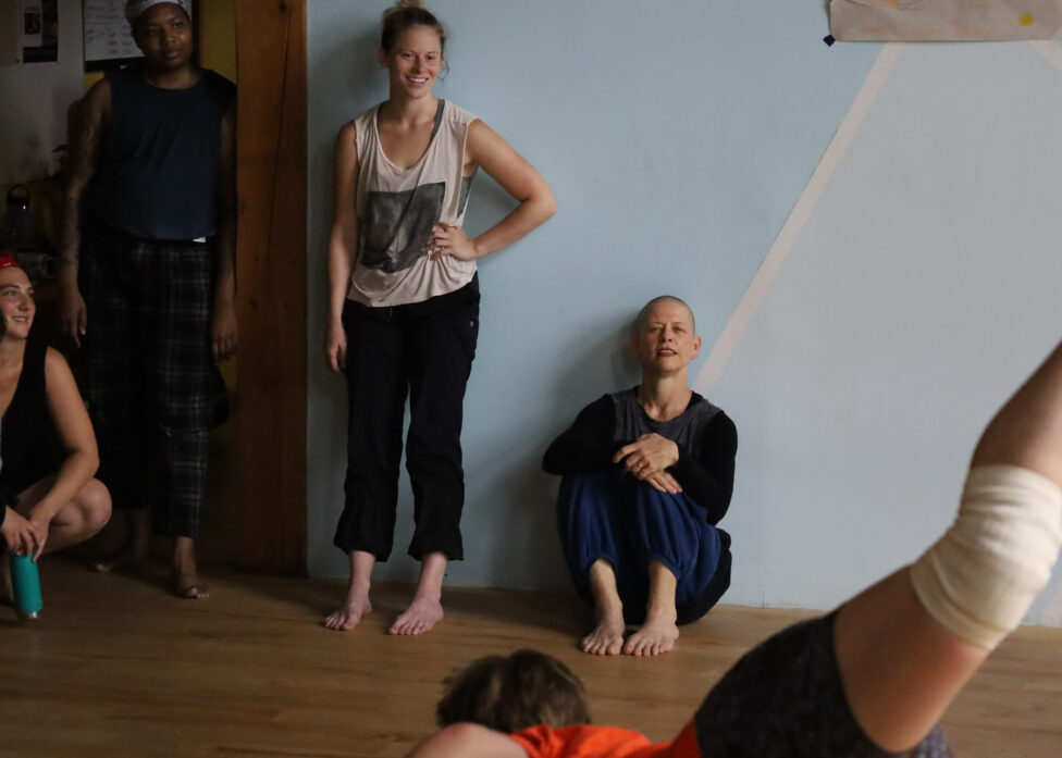 Dancers in the main studio at the Field Center sit on the edges and witness. Photo credit to Rosa Wolff.