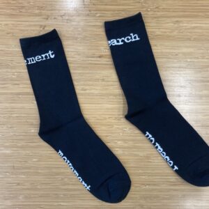 Black socks with white text that says "Movement" and "Research" around the respective ankles and soles of each sock.