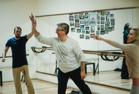 Peter Sciscioli leads participants in an exercise helping to connect their voices into space, extending through their arms and hands.