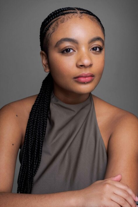 A woman with cornrow braids wearing a halter brown top. Photo courtesy of the artist.