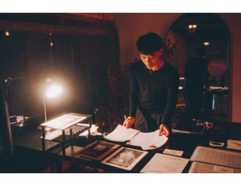 Havi Millar sorting through papers as he works door at an event.