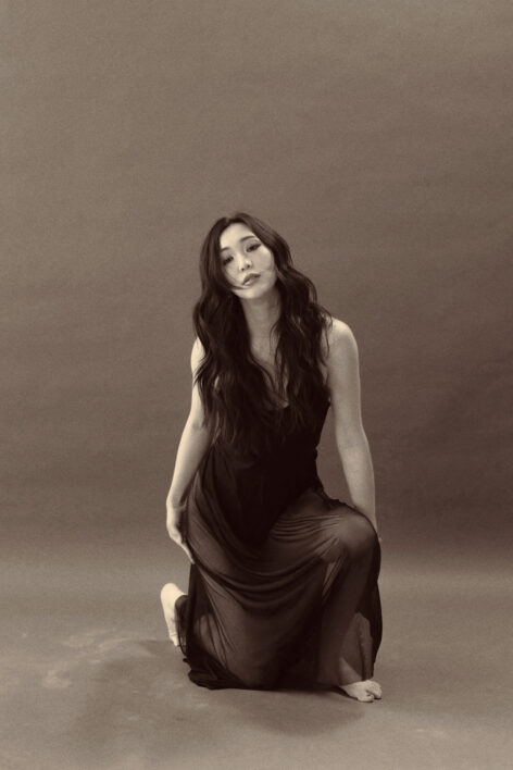 A raven-haired Chinese woman is about to rise.