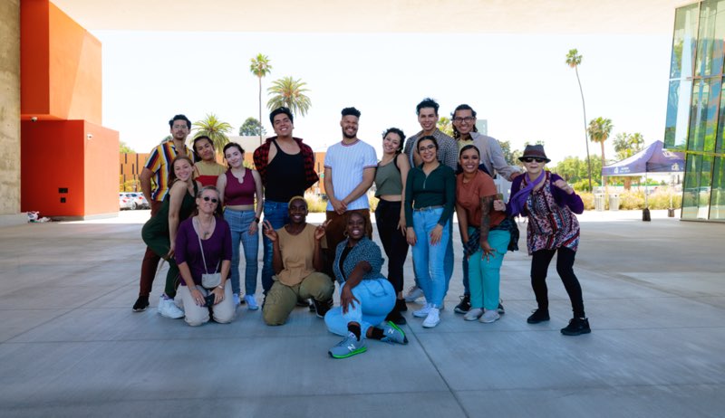Group photo with Robyn, under the breezeway at the Main Library, Riverside, CA Photo includes all performers, plus the choreographers Stephen Tanner and Aisha Shauntel Bardge (center), Edwin Antonio Sigüenza and Sue Roginski (right side of image) and Museum of Riverside Director Robyn Peterson (front left side) “Stories Within” part of inVISIBLE/unHEARD April, 2022. Photo by David Rodriguez.
