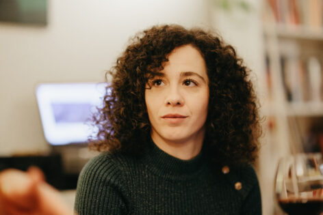 Jelena has curly hair and fair skin, she gazes upward in a portrait by Aleksandar Ramadanović.