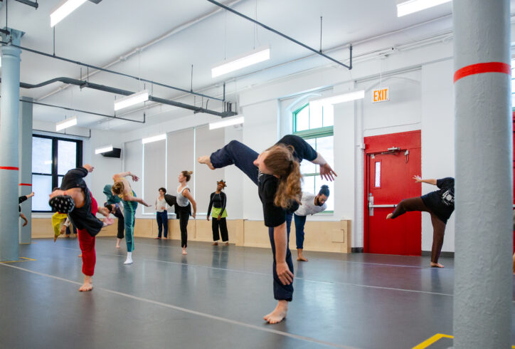 Summer MELT with Jennifer Nugent; Participants in a workshop all balance on one leg and lean to one direction. Photo by Rachel Keane.