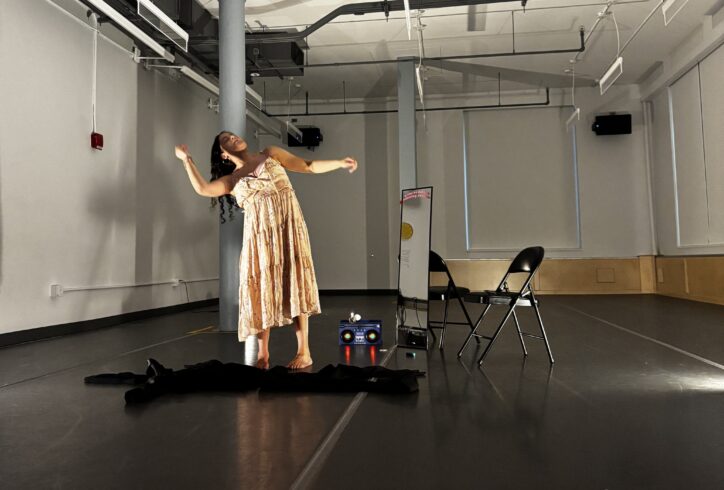 Eris Jaldin wears a flowy pink dress and leans to the side. Photo by MR.