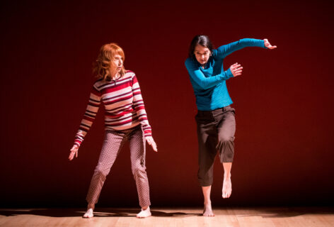 Two women side by side in performance respond to each other as if electrical sparks passed between them. Photo by Ian Douglas.