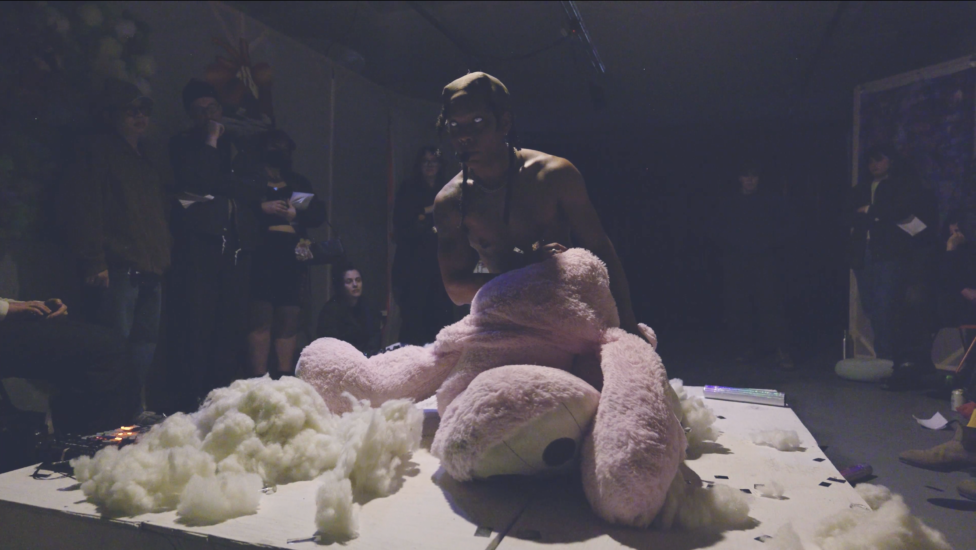Performance stills of Untitled, Test Play (2026). Jordan Deal appears erupting from ripped and shredded teddy bear on small white platform.