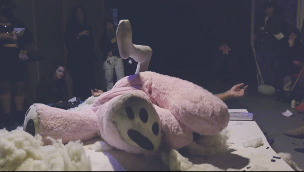 Performance stills of Untitled, Test Play (2026). Jordan Deal appears erupting from ripped and shredded teddy bear on small white platform.